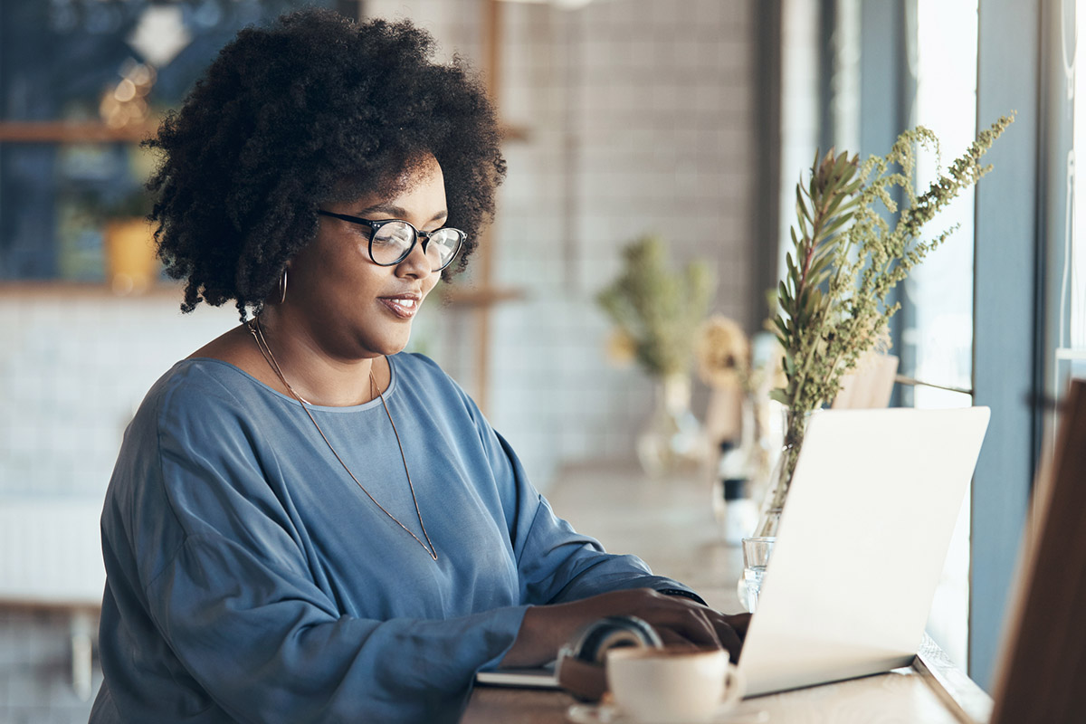 Woman working at a computer and typing up a grant